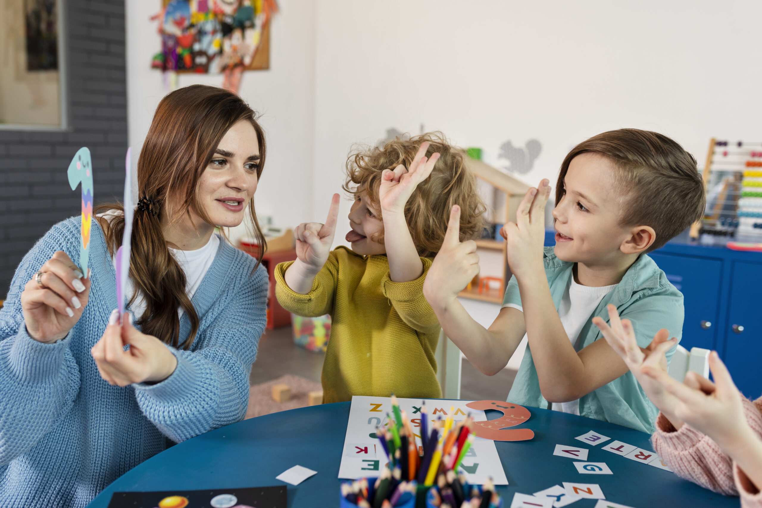 medium-shot-kids-teacher-table